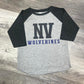 Gray and black baseball shirt with 'NV Wolverines' text on a wooden surface