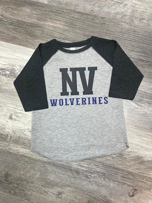 Gray and black baseball shirt with 'NV Wolverines' text on a wooden surface