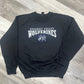 Black sweatshirt with 'Wolverine Nodaway Valley' text on a wooden floor