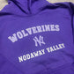 Purple hoodie with 'Wolverines Nodaway Valley' text on a wooden surface