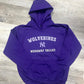 Purple hoodie with 'Wolverines Nodaway Valley' text on a wooden floor